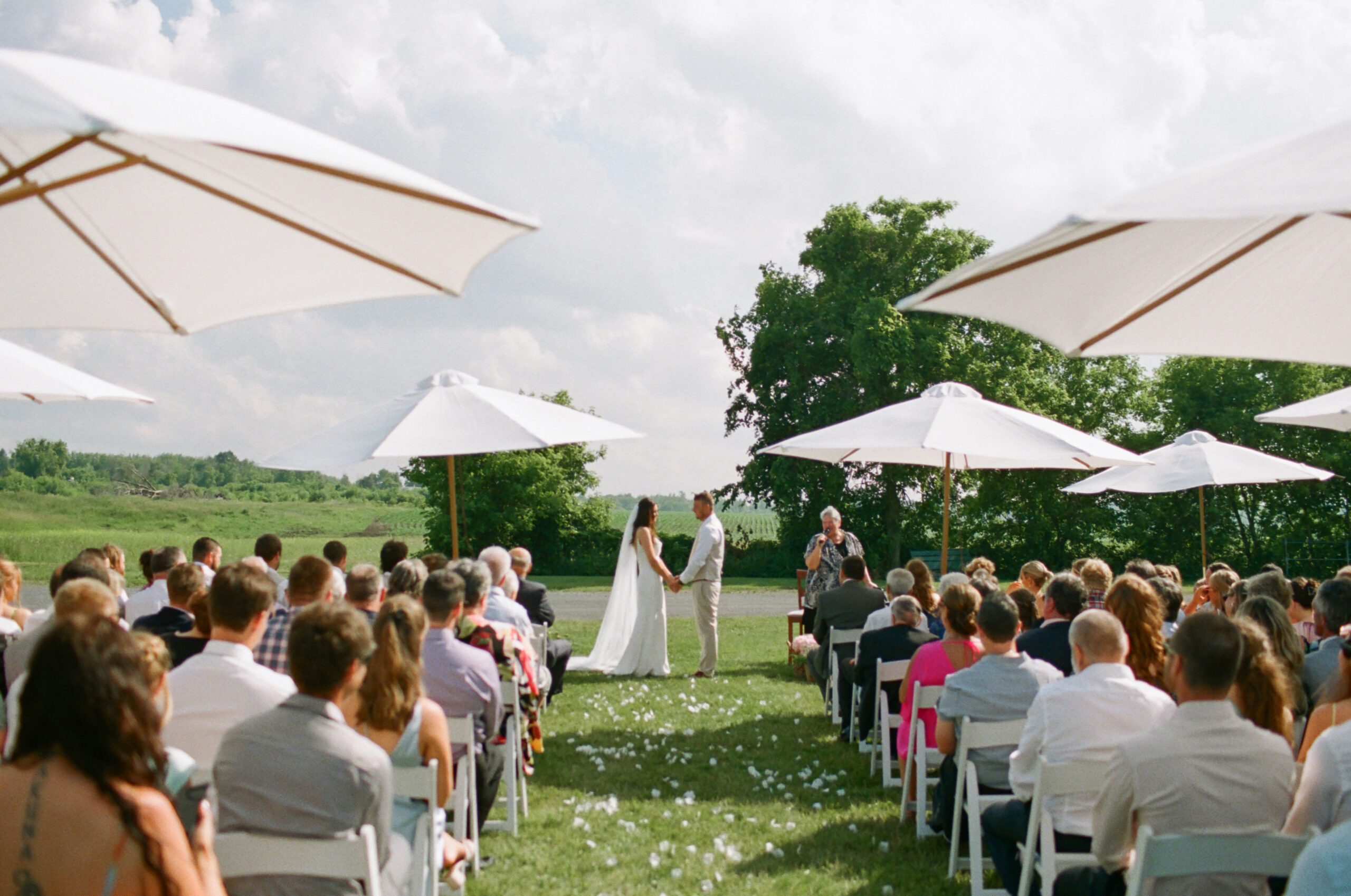 Outdoor Wedding Ceremony with White Umbrellas
