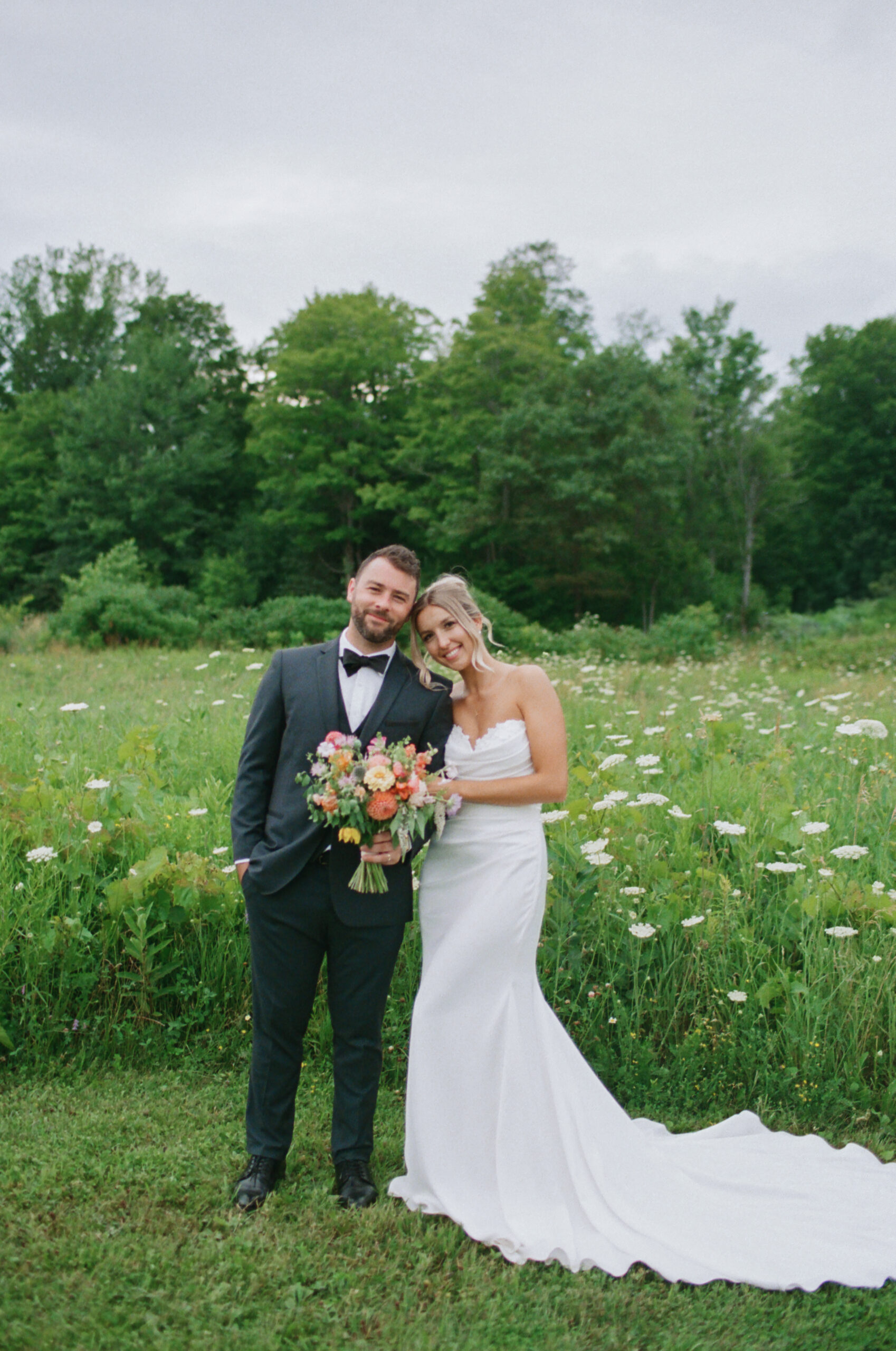 Bride and Groom portrait in wildflower field at Vignoble de Chelsea